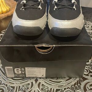 Air Jordan 9 RETRO (GS) size 6 1/2 color black & gray with red inside.